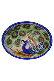 Die handgefertigte Seifenschale Pfauenauge von Tranquillo ziert die wunderschöne, elegante Zeichnung eines Pfaus in kräftigen Farben.