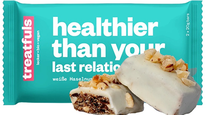 Der °healthier than your last relationship° Riegel von treatfuls ist ein köstlicher Haselnuss-Cashew-Riegel, der von cremiger, weißer, veganer Schoki umhüllt wird.